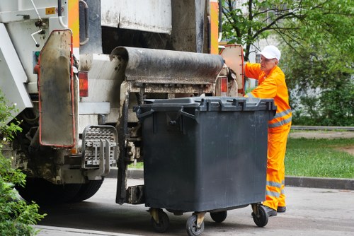 Operator using protective equipment while handling commercial waste